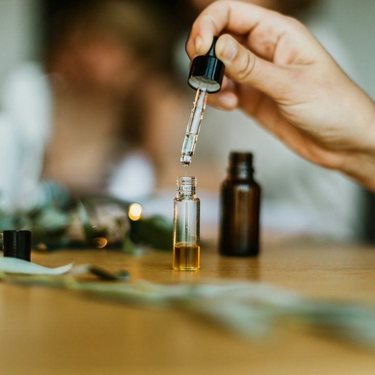 A close up of essential oils being prepared for a tailored aromatherapy blend for a woman's unique needs.
