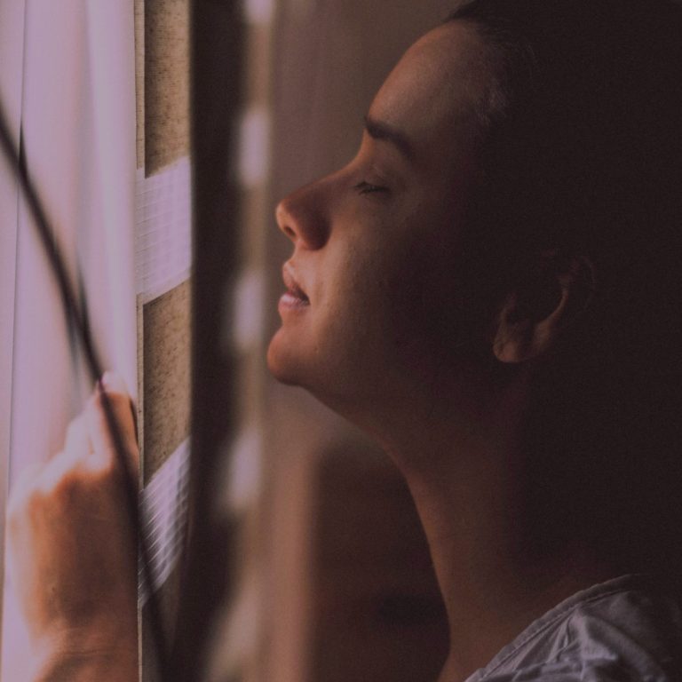 Woman pausing for a quiet moment, symbolising the journey of feeling heard and reconnecting with yourself during menopause.